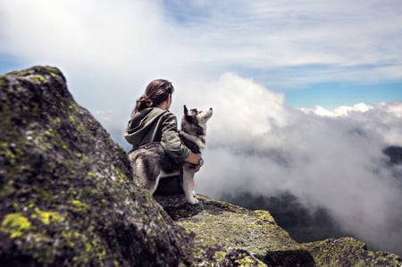 Human and dog enjoy an afternoon in the clouds during a hike